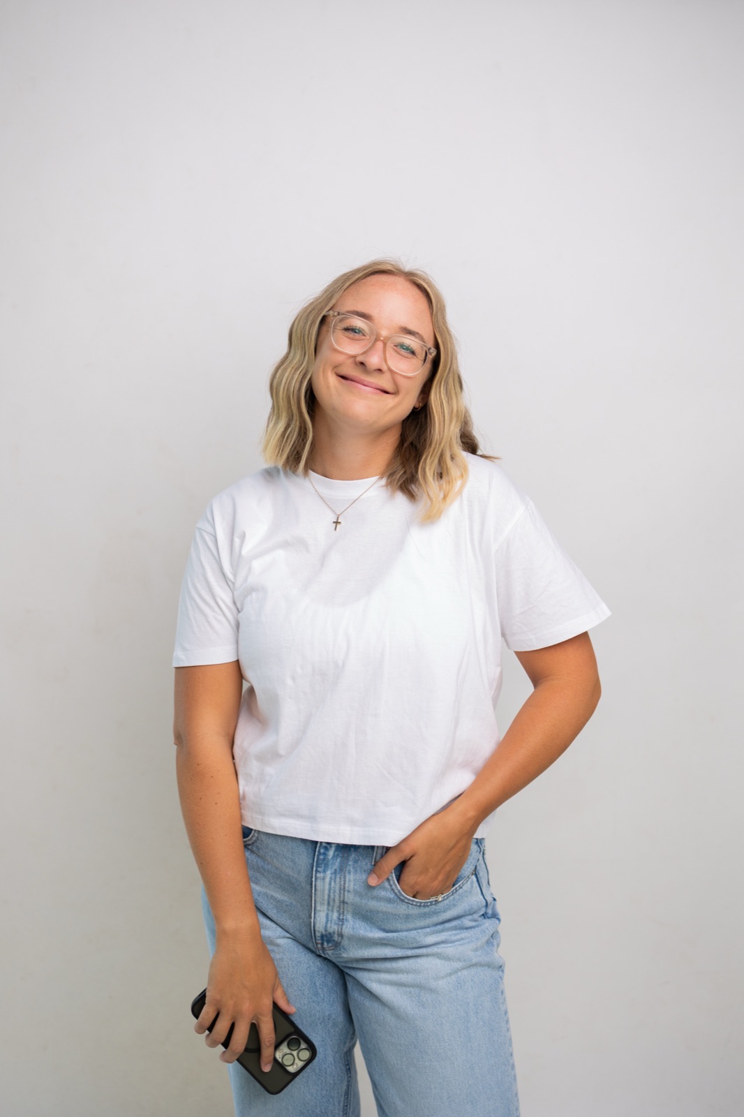 Christina Hedges smiling, phone in hand